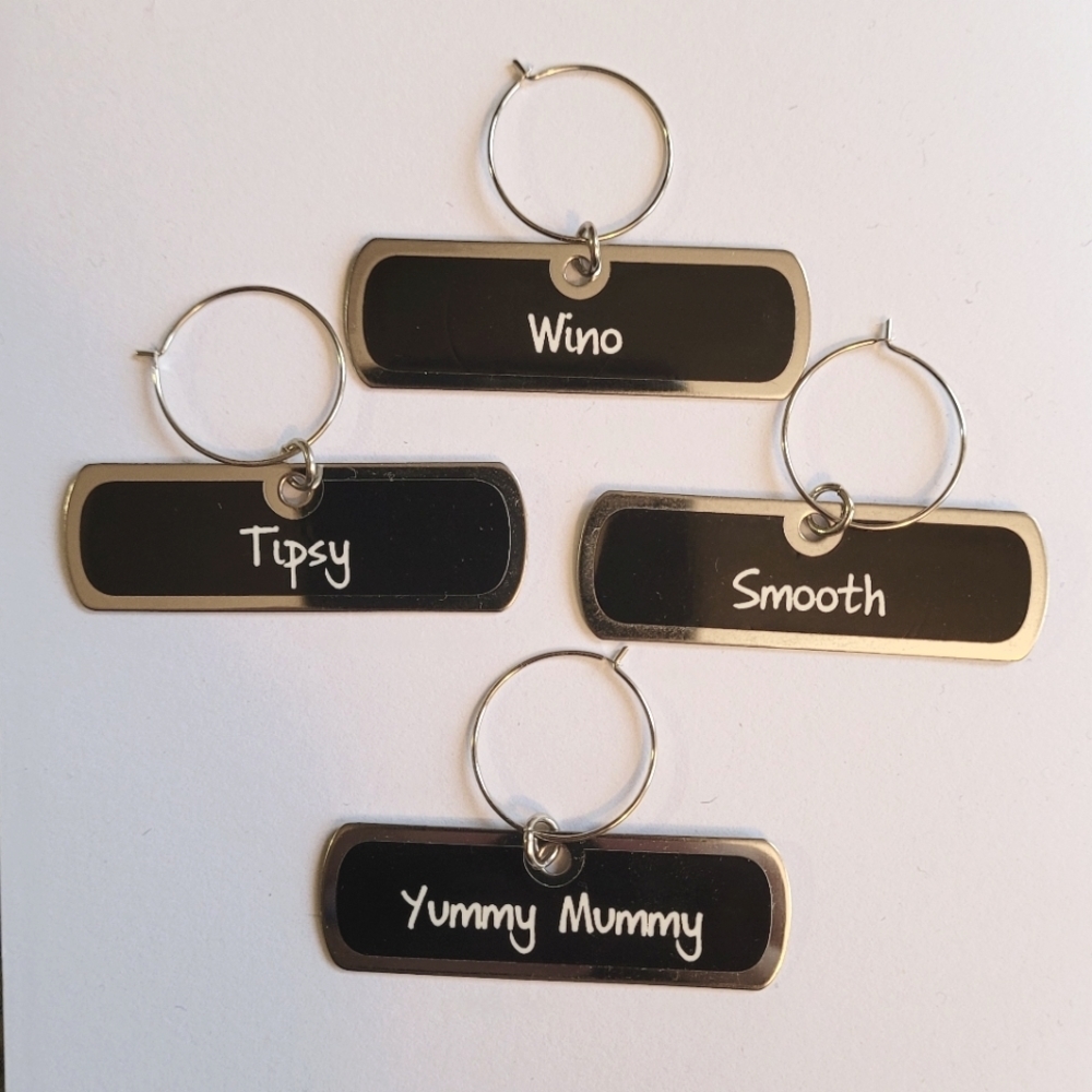 Wine Charms set of four Stainless steel with black background and white NWOT